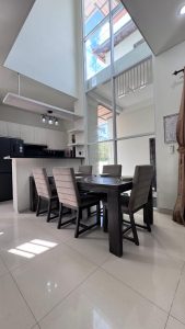 Interior ruang makan rumah mewah semi villa dengan pencahayaan alami dan desain modern.